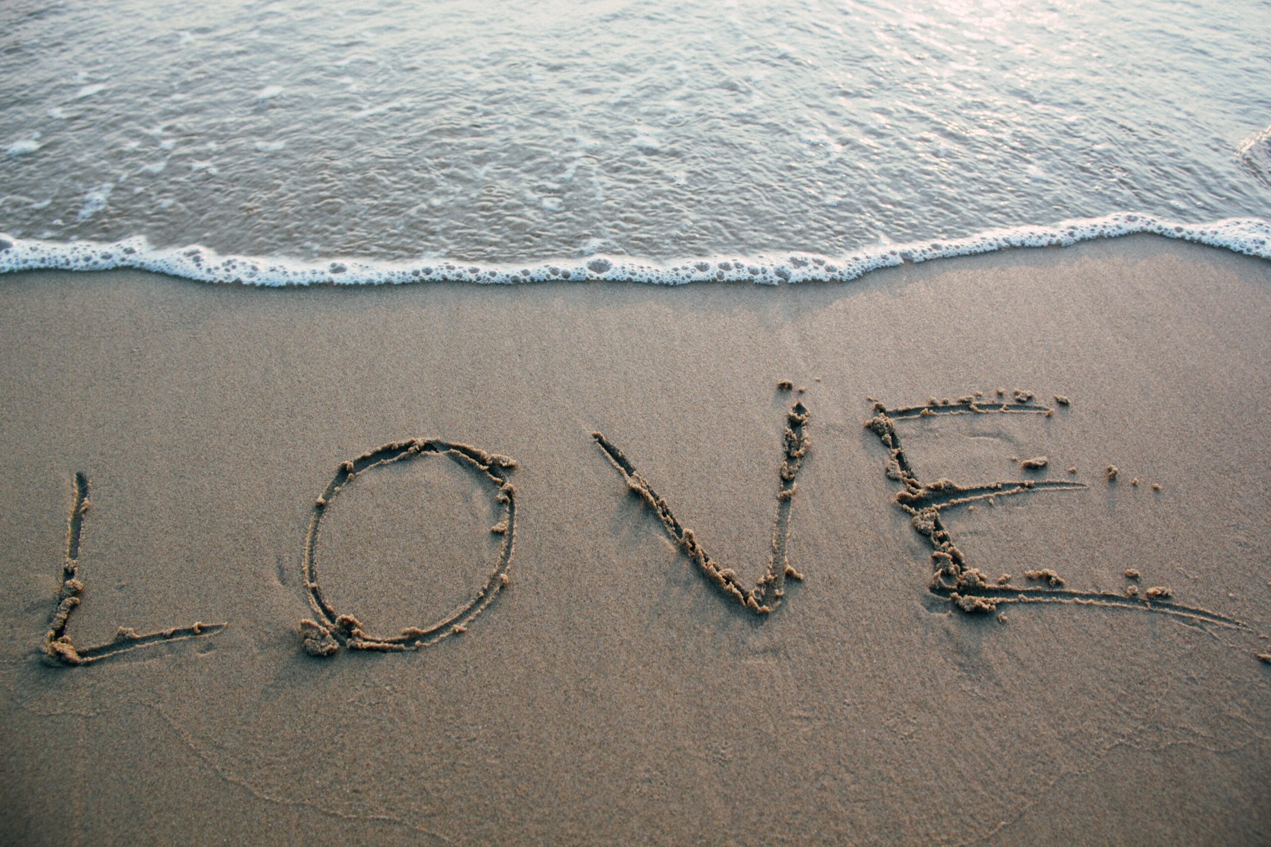 LOVE written in the sand on a beautiful beach